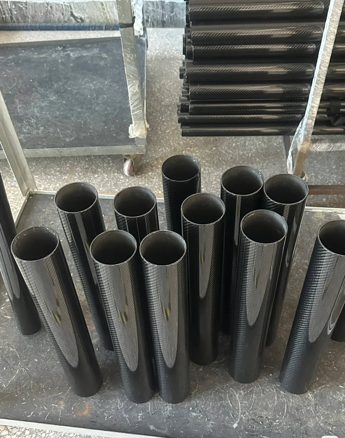 Roll-wrapped carbon fiber tubes in production